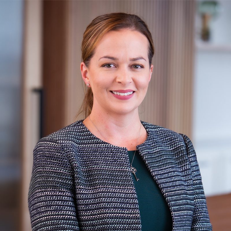 Professional front on, close up image of CEO and commercial property specialist Stacey Jones smiling.